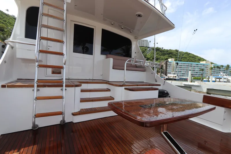 Slide: The Image of Luxury yacht deck with wooden flooring, ladder, and seating area; Buddy Davis 74, 2002 model. - 26