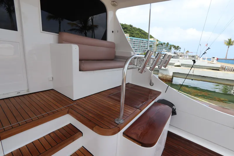 Slide: The Image of Luxurious 2002 Buddy Davis 74 yacht deck with seating and rod holders, docked by the marina. - 27