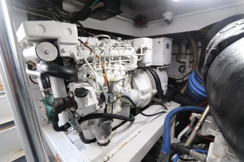 Slide: The Image of Engine room of a 2002 Buddy Davis 74 yacht, showcasing mechanical components. - 30