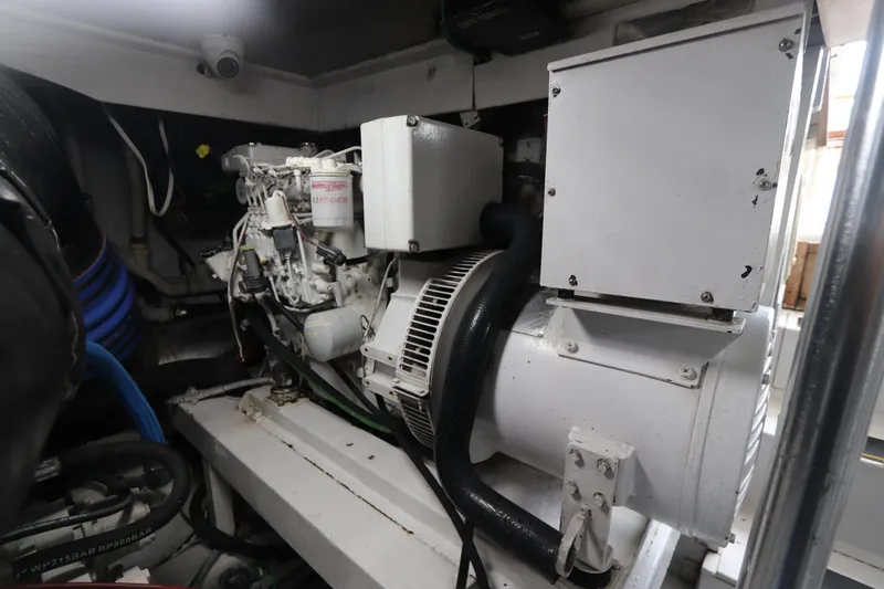 Slide: The Image of Engine room of a 2002 Buddy Davis 74 yacht, showcasing machinery and components. - 31