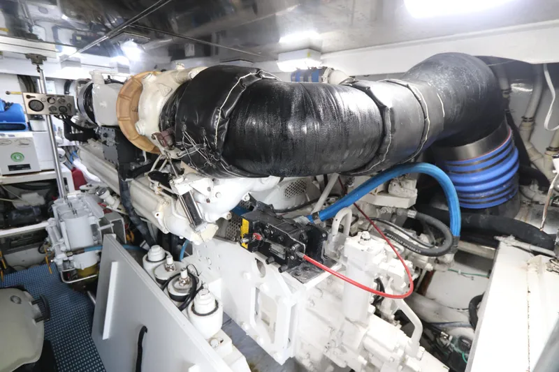 Slide: The Image of Engine room of a 2002 Buddy Davis 74 yacht, showcasing complex machinery and components. - 34
