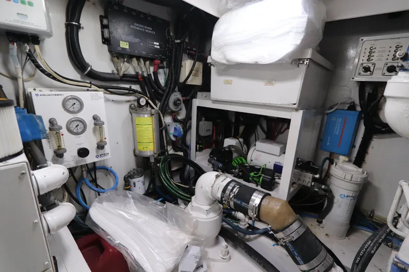 Slide: The Image of Engine room of 2002 Buddy Davis 74 yacht with various mechanical components and gauges. - 35