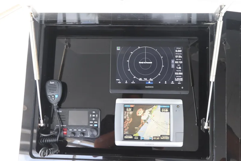 Slide: The Image of Boat navigation equipment on a 2002 Buddy Davis 74, featuring Garmin displays and Icom radio. - 48