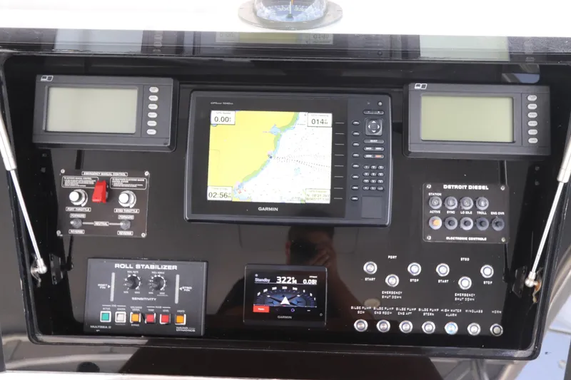 Slide: The Image of Control panel of a 2002 Buddy Davis 74 yacht with navigation and engine systems. - 49