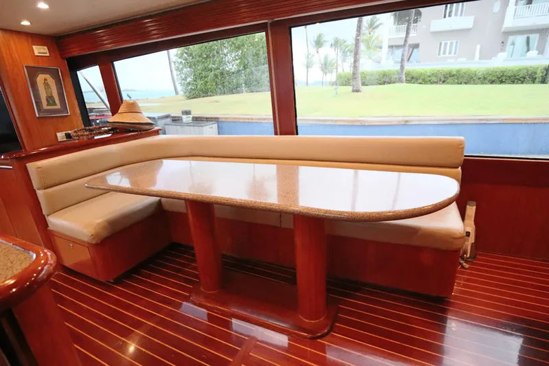 Slide: The Image of Luxurious interior of 2002 Buddy Davis 74 yacht with elegant dining area and panoramic windows. - 6