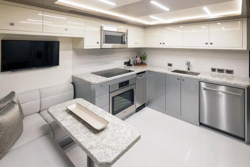 Slide: The Image of Modern kitchen in 2023 Ocean Alexander 30R yacht with sleek appliances and dining area. - 29