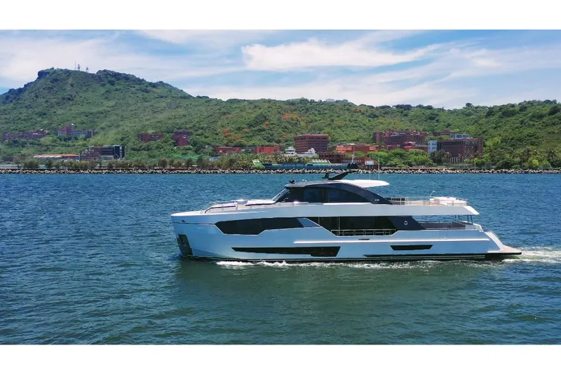 Slide: The Image of 2023 Ocean Alexander 30R yacht cruising on a scenic coastal waterway. - 6