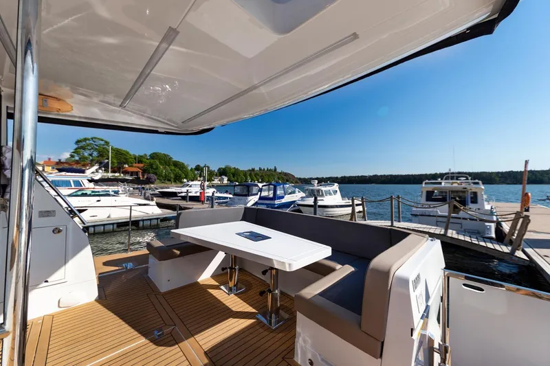 Slide: The Image of Galeon 470 Sky 2023 yacht with outdoor seating area docked at a marina. - 10