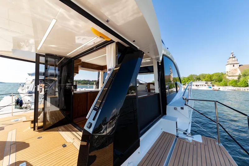 Slide: The Image of 2023 Galeon 470 Sky yacht with open deck and scenic waterfront view. - 12