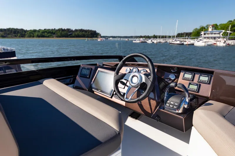 Slide: The Image of 2023 Galeon 470 Sky yacht helm with modern navigation system and waterfront view. - 16