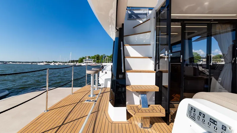 Slide: The Image of 2023 Galeon 470 Sky yacht deck with stairs and waterfront view. - 18