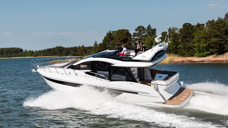 Slide: The Image of 2023 Galeon 470 Sky yacht cruising on a scenic lake. - 2
