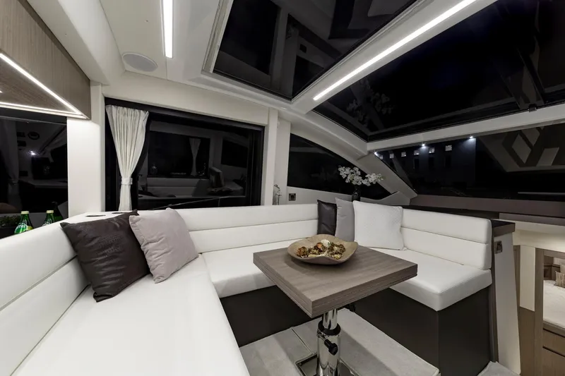 Slide: The Image of Luxurious interior of the 2023 Galeon 470 Sky yacht with modern seating and table. - 23