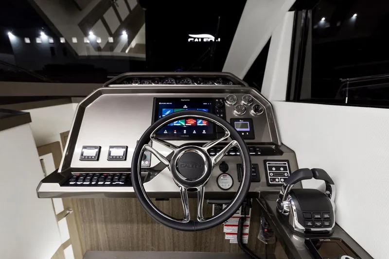 Slide: The Image of 2023 Galeon 470 Sky yacht helm with modern controls and touchscreen display. - 25
