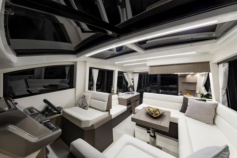 Slide: The Image of Luxurious interior of 2023 Galeon 470 Sky yacht with modern seating and panoramic windows. - 26