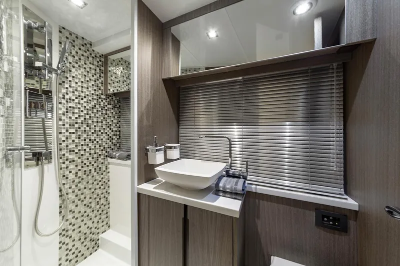 Slide: The Image of Modern bathroom in 2023 Galeon 470 Sky yacht with mosaic tiles and vessel sink. - 31