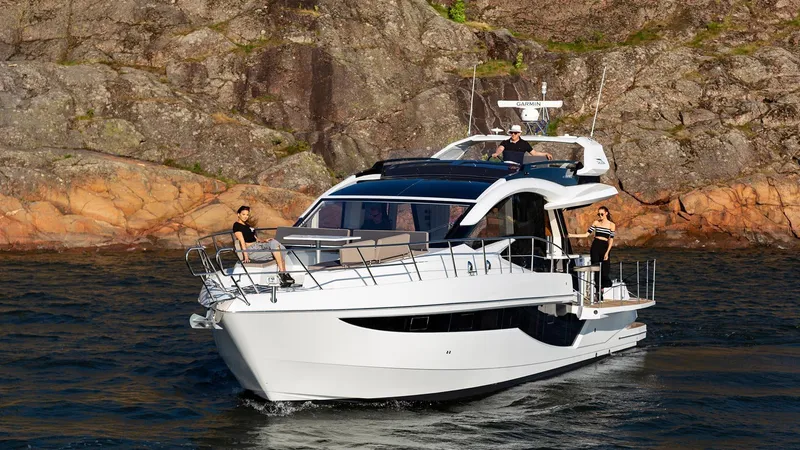 Slide: The Image of 2023 Galeon 470 Sky yacht cruising near rocky shoreline. - 5