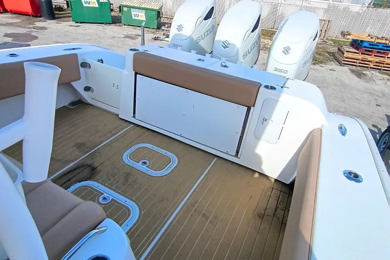 Slide: The Image of 2019 Cape Horn 36XS boat interior with Suzuki engines, featuring cushioned seating and wooden flooring. - 8