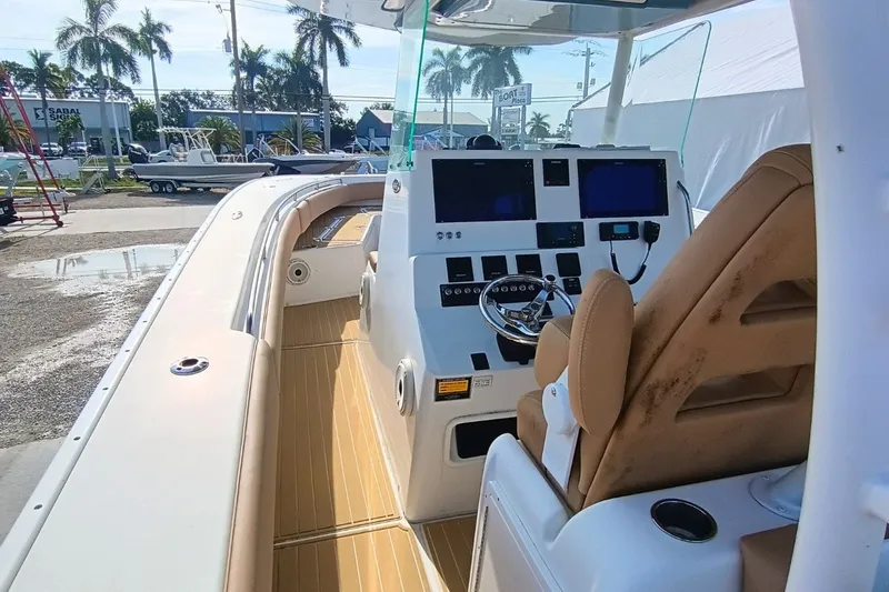 Slide: The Image of 2019 Cape Horn 36XS boat interior with helm, steering wheel, and navigation screens. - 6