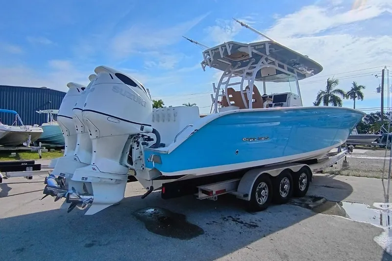 Slide: The Image of 2019 Cape Horn 36XS boat with dual Suzuki outboard engines on a trailer. - 2