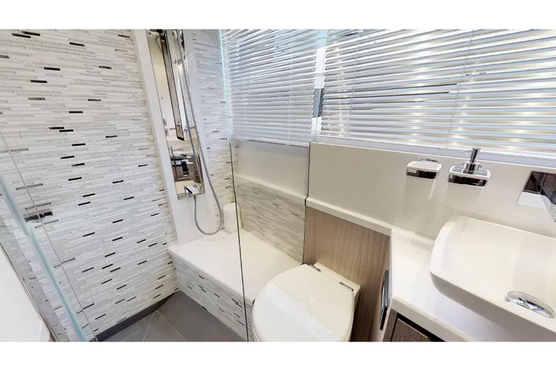 Slide: The Image of Modern bathroom in 2023 Galeon 650 Sky yacht with sleek design and glass shower. - 16