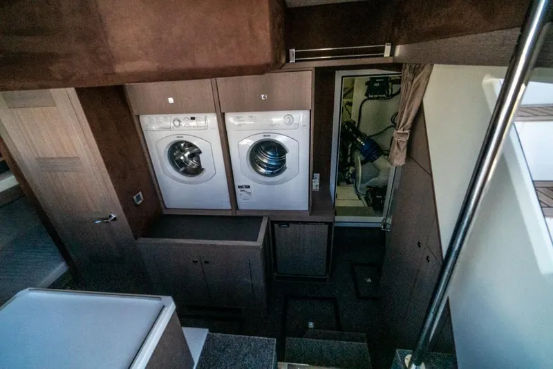 Slide: The Image of Laundry area in 2023 Galeon 650 Sky yacht with washer and dryer. - 21