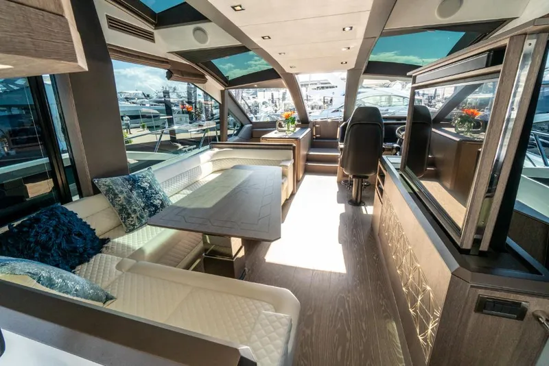 Slide: The Image of Luxurious interior of the 2023 Galeon 650 Sky yacht with modern seating and dining area. - 3