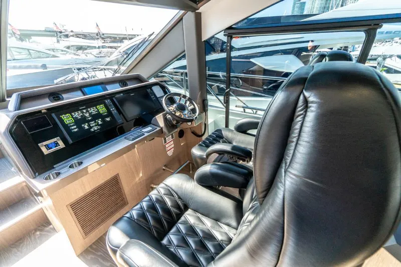 Slide: The Image of 2023 Galeon 650 Sky yacht cockpit with leather seats and modern dashboard. - 7