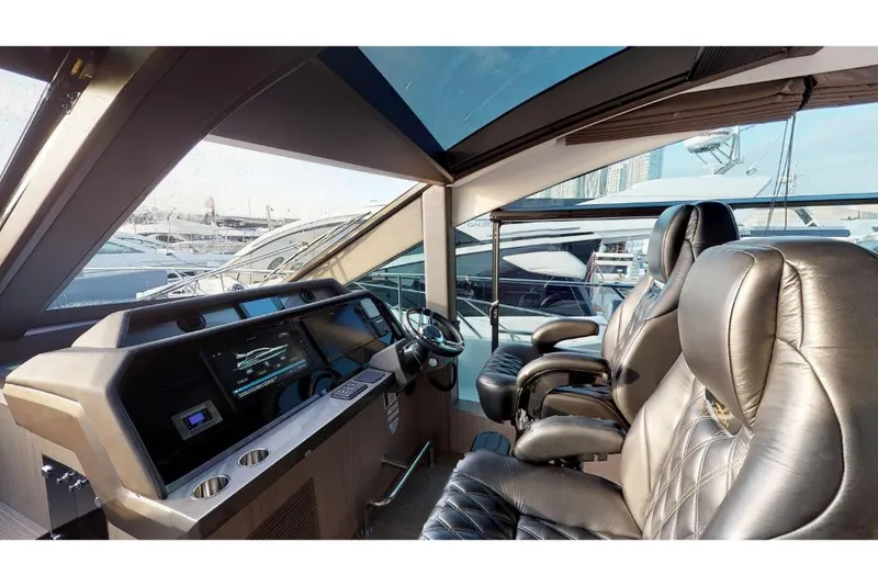 Slide: The Image of Interior helm of 2023 Galeon 650 Sky yacht with leather seats and modern controls. - 8