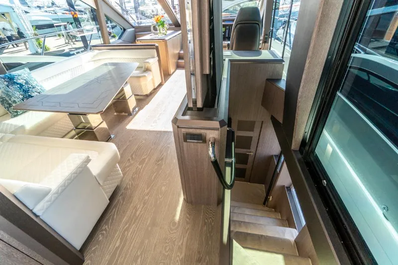 Slide: The Image of Luxurious interior of the 2023 Galeon 650 Sky yacht with modern seating and dining area. - 9