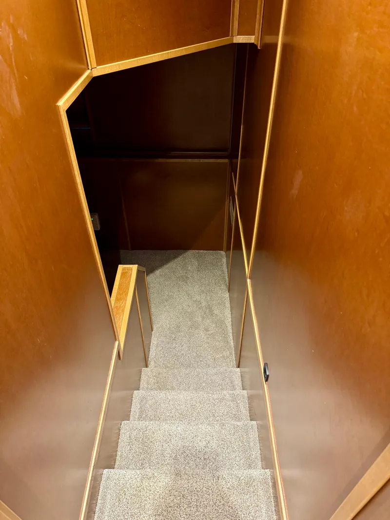 Slide: The Image of Carpeted stairs inside 2012 Bravada Helios Trip #7, featuring wooden walls. - 19