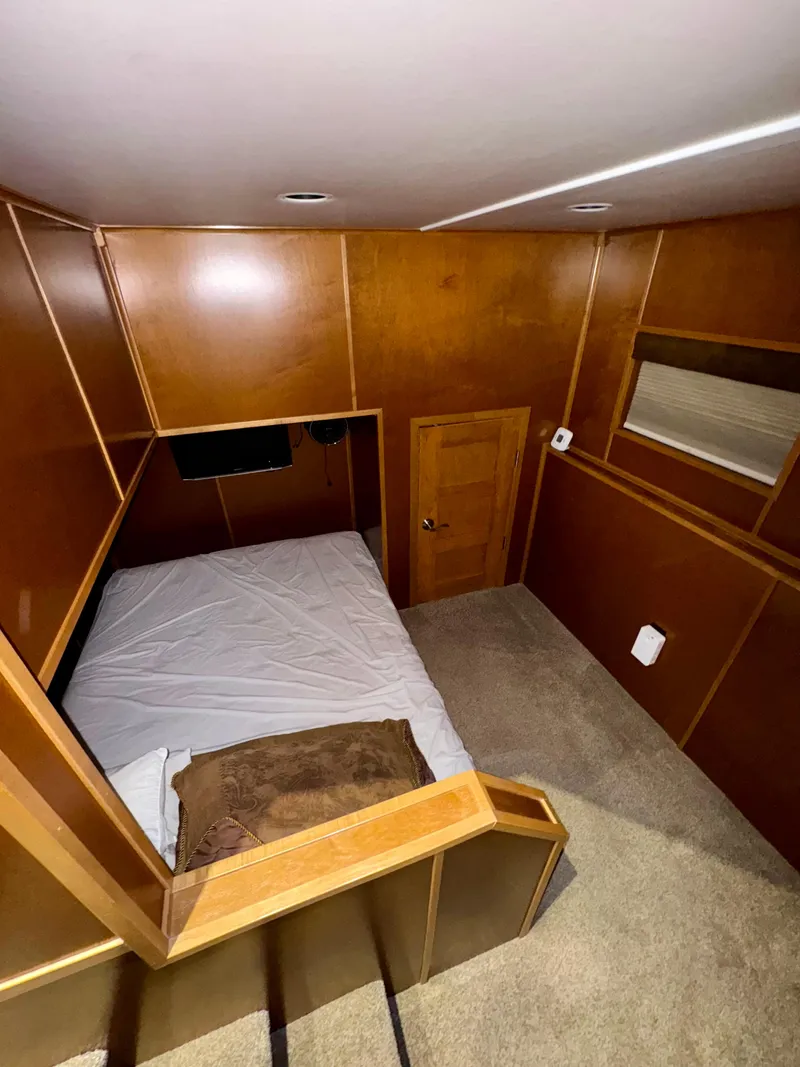 Slide: The Image of Interior of 2012 Bravada Helios Trip #7, featuring a cozy bedroom with wood paneling. - 20