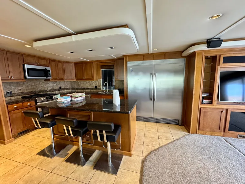 Slide: The Image of Luxurious kitchen in 2012 Bravada Helios Trip #7 with modern appliances and bar seating. - 23