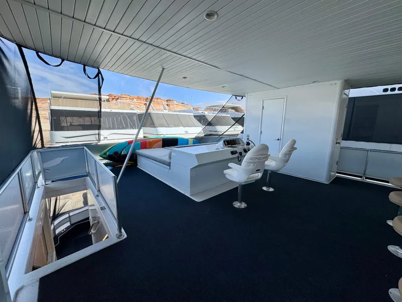Slide: The Image of Spacious deck of 2012 Bravada Helios Trip #7 houseboat with seating and helm. - 24