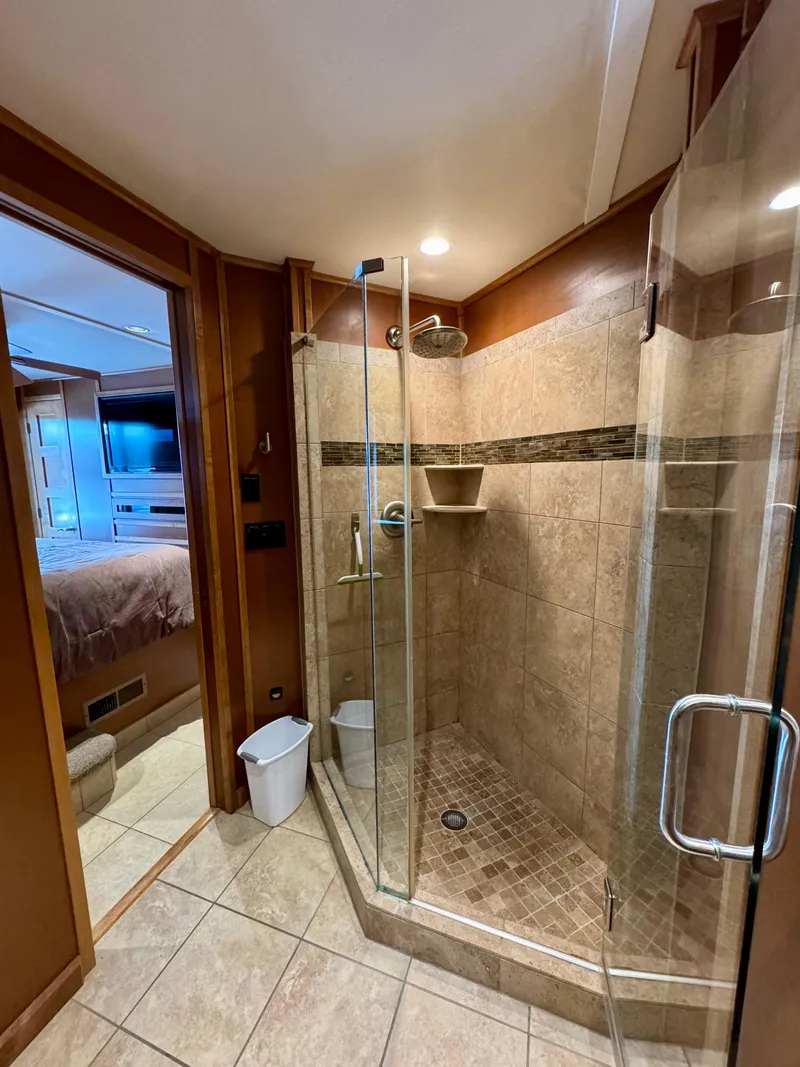 Slide: The Image of Cozy bedroom in 2012 Bravada Helios Trip #7 with wood cabinetry and carpeted flooring. - 13