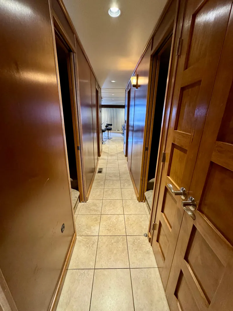 Slide: The Image of Cozy bedroom in 2012 Bravada Helios Trip 7 houseboat with wood paneling and TV. - 14