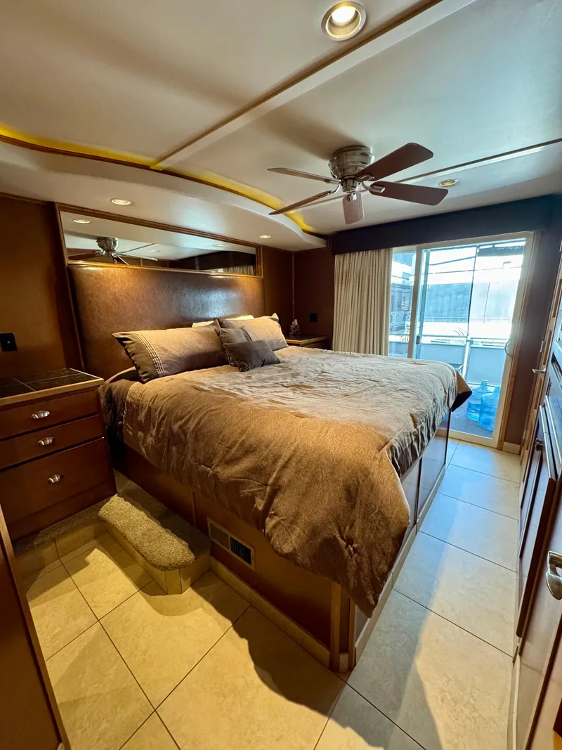 Slide: The Image of Narrow hallway with wooden doors and tiled floor inside Bravada Helios Trip #7, 2012 model. - 9