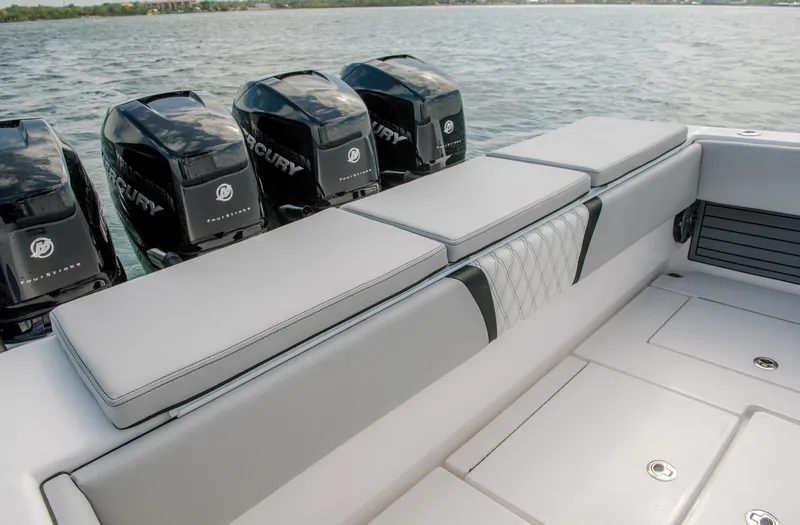 Slide: The Image of Contender 39 Fisharound 2025 boat with Mercury engines and cushioned seating. - 13