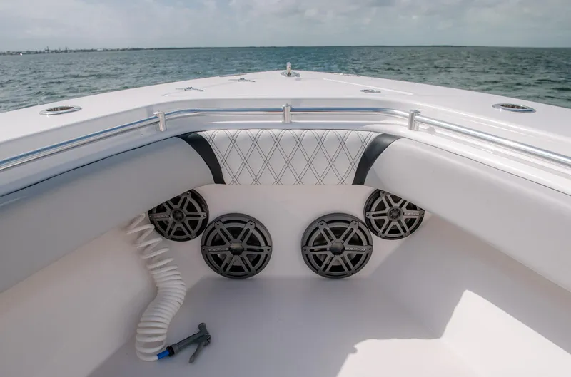Slide: The Image of 2025 Contender 39 Fisharound boat bow with speakers and cushioned seating. - 23