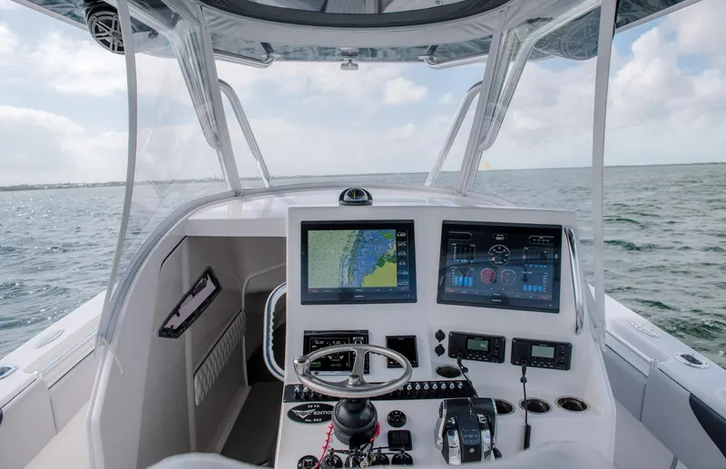 Slide: The Image of 2025 Contender 39 Fisharound boat cockpit with advanced navigation systems. - 25