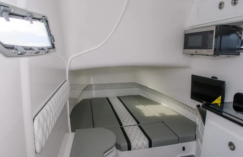 Slide: The Image of Interior cabin of 2025 Contender 39 Fisharound with bed, microwave, and TV. - 27