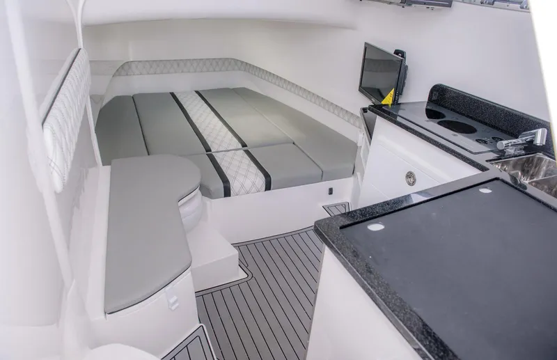 Slide: The Image of Interior cabin of 2025 Contender 39 Fisharound boat with bed, kitchenette, and seating. - 33