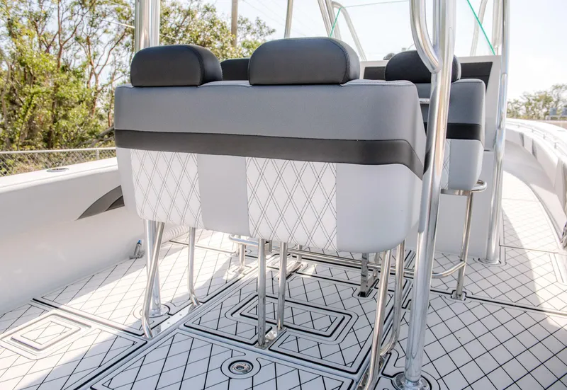 Slide: The Image of 2025 Contender 39 Fisharound boat interior with cushioned seats and diamond-patterned flooring. - 5
