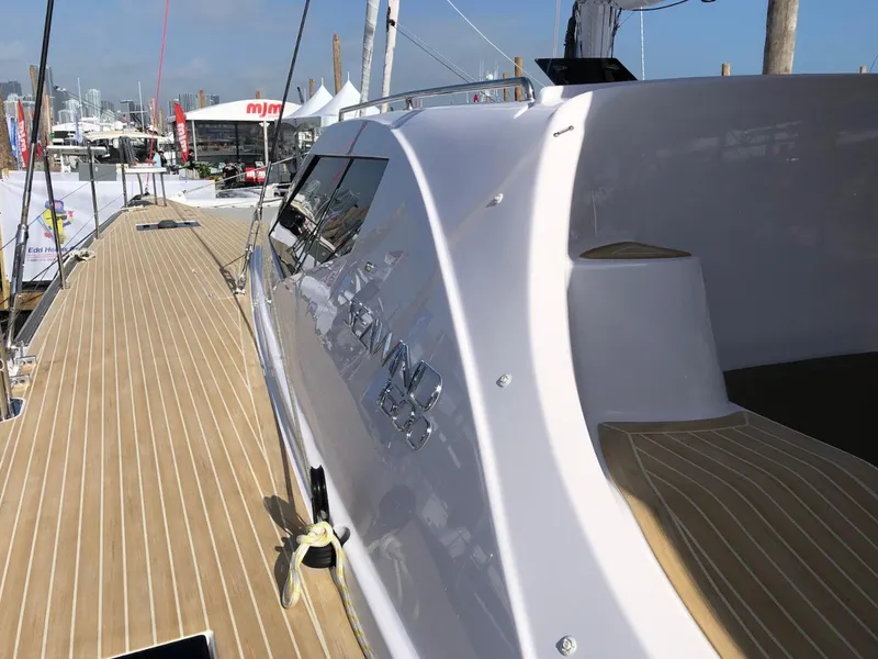 Slide: The Image of 2025 Seawind 1600 yacht with sleek design and wooden deck at a marina. - 11