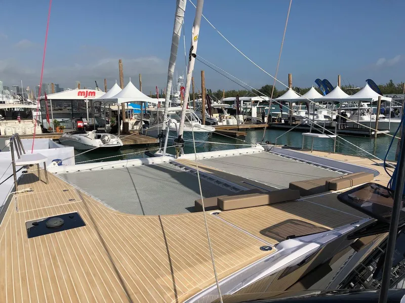Slide: The Image of 2025 Seawind 1600 catamaran docked at marina with clear skies. - 14