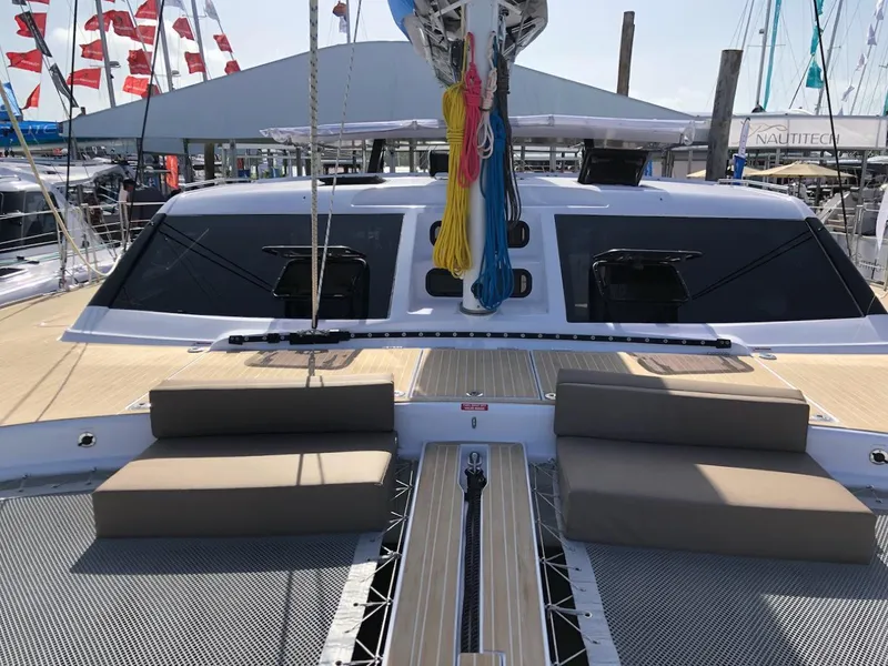 Slide: The Image of 2025 Seawind 1600 catamaran deck with seating and colorful ropes, docked at marina. - 15