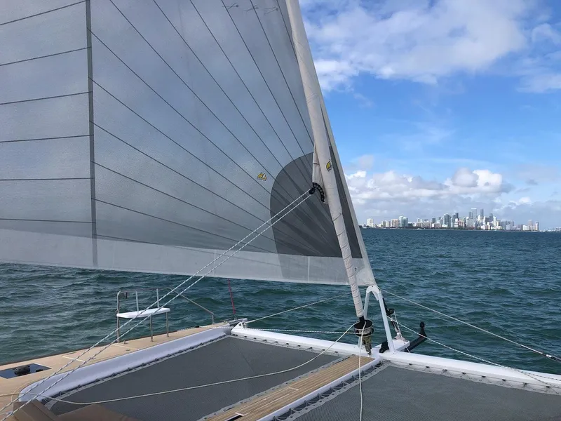 Slide: The Image of 2025 Seawind 1600 catamaran sailing with city skyline in background. - 18