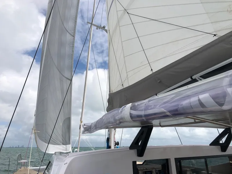 Slide: The Image of 2025 Seawind 1600 catamaran sailing with full sails on a cloudy day. - 19