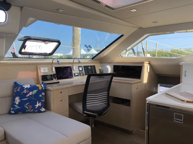 Slide: The Image of Interior of 2025 Seawind 1600 yacht with modern navigation station and seating area. - 2