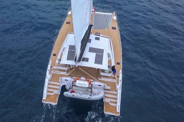Slide: The Image of 2025 Seawind 1600 catamaran sailing on open water, aerial view. - 20